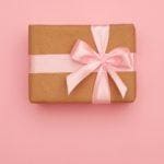 Present box with pink bow placed in the middle