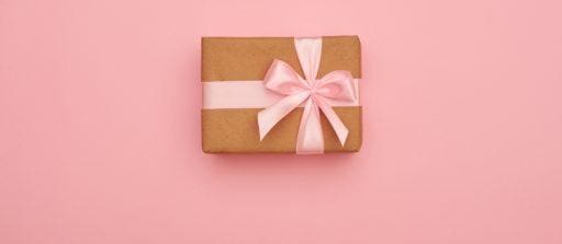 Present box with pink bow placed in the middle