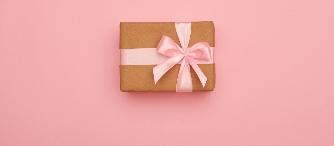 Present box with pink bow placed in the middle